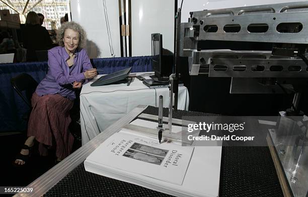 Thumbnail of Margaret Atwood uses her LongPen invention for signing books remotely...